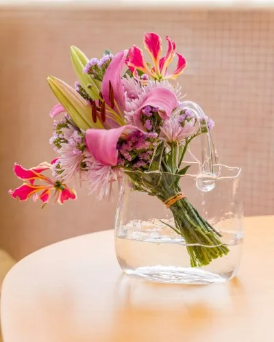 Vaso transparente em formato de bolsa com flores